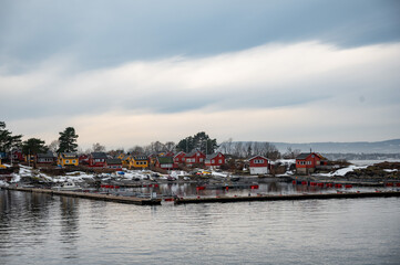 Fototapeta premium Traditional cottages on the islands around Oslo, Norway in winter. Islands with houses