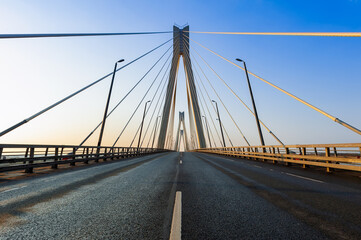 Obraz premium Cable-stayed bridge in the light of the morning sun and against the background of a clear blue sky. Murom. Russia.