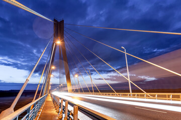 Cable-stayed bridge at sunset against a beautiful sky and in the rays of evening lighting. Moore....