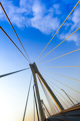 Cable-stayed bridge in the light of the morning sun and against the background of a clear blue sky. Murom. Russia.