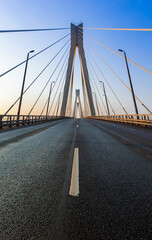 Cable-stayed bridge in the light of the morning sun and against the background of a clear blue sky. Moore. Russia.