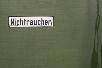 German sign no smoking in german called Nichtraucher at green background from train