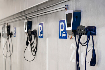 Electric Vehicle Charging Station in Private Garage Parking lot of Multifamily Building with...