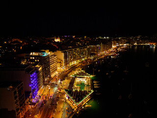 Sliema promenade at night with hotels, restaurants, main road and streetlights. Aerial view on a...
