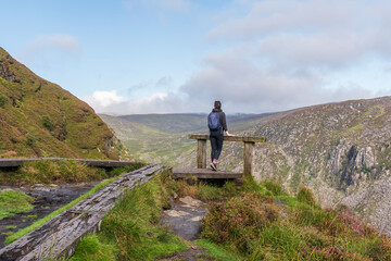 Hiker enjoying the view from the Spinc ridge. Scenic Irish landscape from Glendalough in Wicklow...