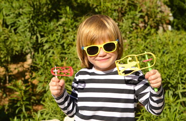 Purim. A child with a grager and ratchet celebrates the Jewish joyful holiday of spring. Concept:...