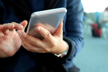 Close-up of a woman's hands holding and using a smartphone