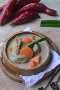 Kolak pisang or kolek pisang Indonesian traditional dessert made from banana, red sweet potato, brown sugar and coconut milk. 
