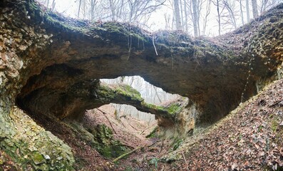 A unique natural phenomenon in the form of a stone bridge. The time of year is autumn or winter.