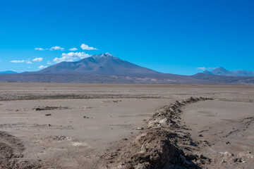 The desert of the Salar de Chiguana, near the border with Chile, surrounded by majestic multicolored volcanos, Potosi department, Bolivia