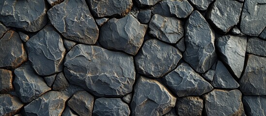 A detailed view of a stone wall crafted with large rocks showcasing the intricate pattern and texture of grey bedrock.