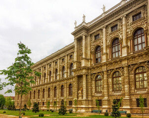 blooming chestnut near a beautiful building, beautiful building, cloudy weather, young flowering trees