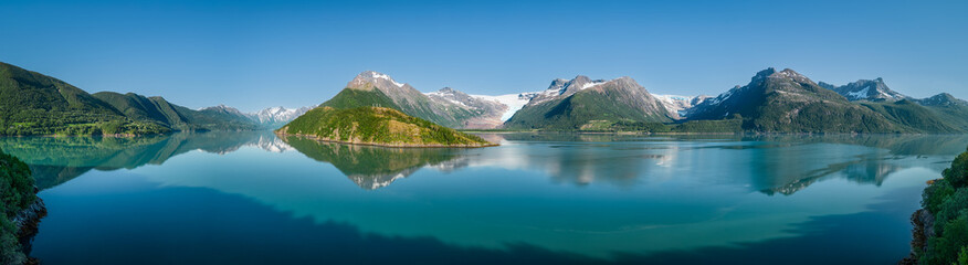 Naklejka na ściany i meble An idyllic super panorama of the Svartisen Glacier vicinity, with the Saltfjell mountain range reflected in the tranquil fjord waters of Norway