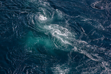 The deep blue of Saltstraumen whirlpool waters is accentuated by the vigorous dance of tidal...