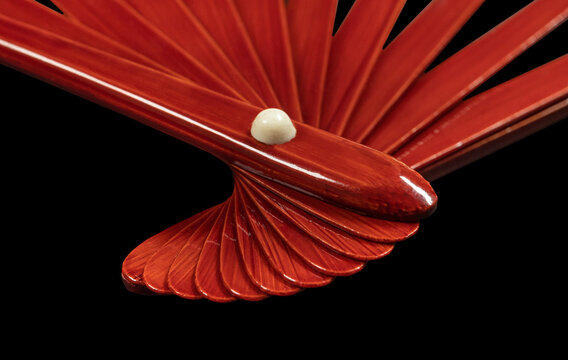 Japanese traditional hand fan from bamboo and paper or silk isolated on black