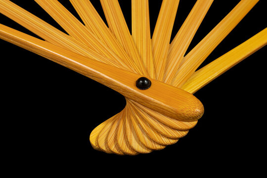 Japanese traditional hand fan from bamboo and paper or silk isolated on black