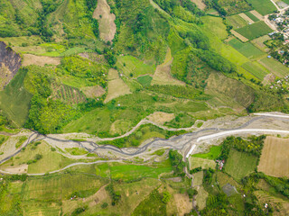 Top view of Farm fields with water flowing over the river. Mindanao, Philippines.