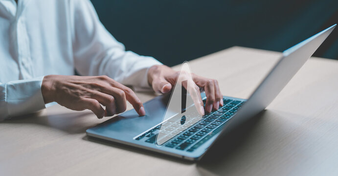 Businessman or programmer, developer using computer laptop with triangle caution warning sign for notification error and maintenance concept. Virus detected warning, Cybercrime protection.	