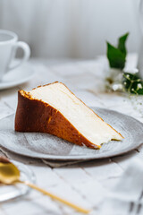 Popular Spanish dessert called San Sebastian cheesecake. It also known as burnt cheesecake. One piece of this dessert on white background.