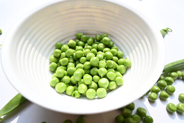 Fresh green pea on white background. There is a lot of vitamins  and Minerals in it. The pea is most commonly the small spherical seed or the seed. Popular vegetable of all over world. 