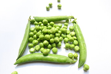 Fresh green pea on white background. There is a lot of vitamins  and Minerals in it. The pea is most commonly the small spherical seed or the seed. Popular vegetable of all over world. 