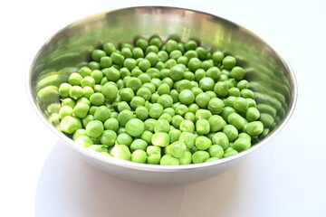 Fresh green pea on white background. There is a lot of vitamins  and Minerals in it. The pea is most commonly the small spherical seed or the seed. Popular vegetable of all over world. 