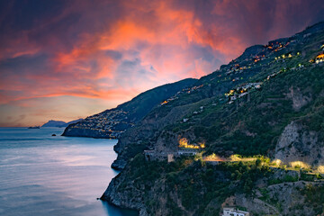 Amalfi Coast, Italy. View over Praiano on the Amalfi Coast at sunset. Street and house lights at...