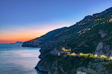 Amalfi Coast, Italy. View over Praiano on the Amalfi Coast at dusk. Street and house lights at...