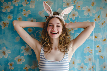 Happy young woman wearing easter rabbit headband with ears on background.
