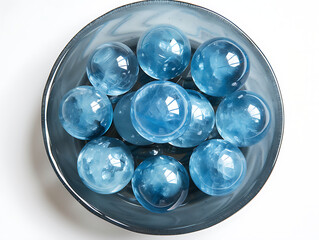 a group of blue colored crystal balls in a dish in th