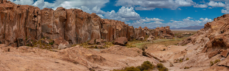 Obraz premium Laguna Catal, a stunning lake surrounded by eroded lava boulders, populated by herds of semi-wild llamas, Bolivia