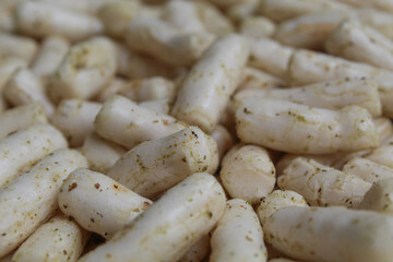 Fish crackers in small cylinder shape. Snack from Indonesia, called krupuk ikan tongkol. Flat lay or top view