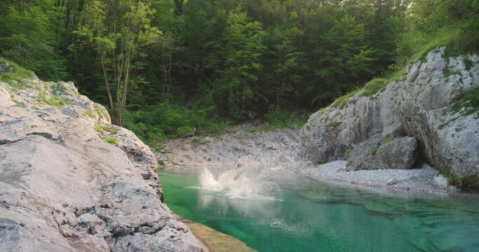 Women, cliff and jump at lake for travel holiday at forest mountain for summer, vacation or nature. Female people, friends and rock pool or leap at tropical island in Bali or swim, explore or outdoor