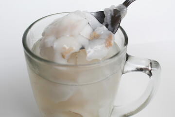 Beverage made from chilled or iced coconut water and young coconut flesh, isolated on white...