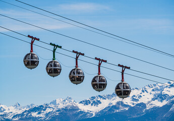 Gondola bubbles against the blue sky and the French Alps in the background. Cable car taking...