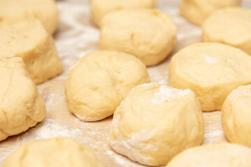 Fototapeta na wymiar Pieces of dough on the table in flour.