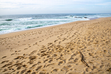 footprints on the beach over the sea