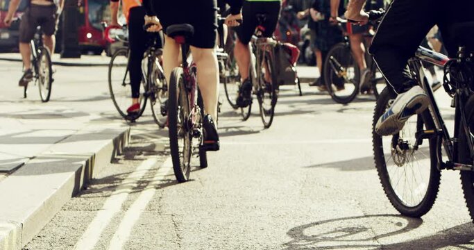 Race, bicycle and legs in the city with training, workout and sport marathon for cycling in town. Urban road, street and athlete group with cyclist, fitness and exercise together in town in New York