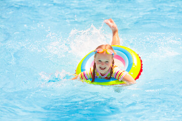 Child in swimming pool. Kids swim. Water play.