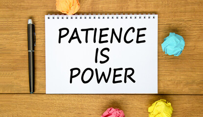 Patience is power symbol. Concept words Patience is power on beautiful white note. Beautiful wooden background. Black pen. Colored paper. Business and patience is power concept. Copy space.