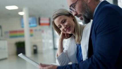 Pharmaceutical sales representative talking with doctor in medical building. Female doctor talking with hospital director, manager in private clinic. - Powered by Adobe