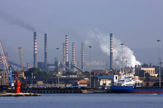 Acciaierie d'Italia steel industry (formerly Ilva, ArcelorMittal and Italsider). Pollution from chimneys on the Tamburi neighborhood of Taranto, Puglia, Italy