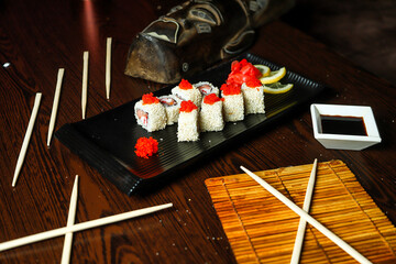 Black Plate With Sushi and Chopsticks