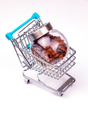 Seeds of coffee in glass transparent capacity in shopping cart