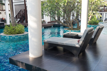 Bedchairs on patio of swimming pool villa in luxury resort