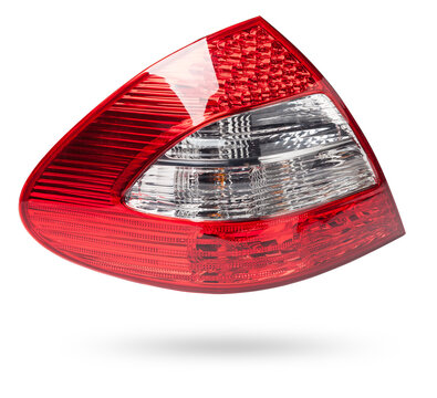 Stylish headlight stop signal made of white and red transparent glass on a white isolated background in a photo studio. Detail for replacement and sale in a car service.