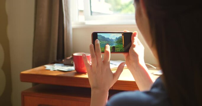 Phone, screen and woman looking at pictures for social media or internet in living room at home. Rest, photography and closeup of female person swipe images on cellphone relaxing in apartment.