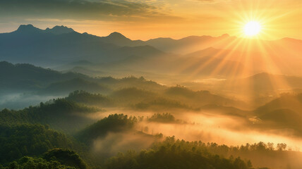 The sun is seen descending behind the majestic mountains. Misty nature background.