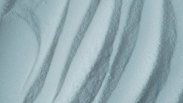 Texture of Sodium erythorbate or Sodium isoascorbate powder, close-up. Food additive E316 with chemical formula C6H7NaO6 used predominantly in meats, poultry, and soft drinks. 4K video, rotating.