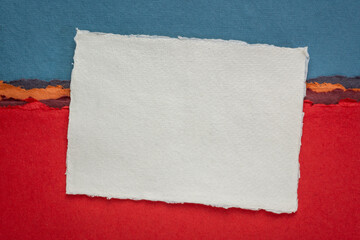 small sheet of blank white Khadi rag paper from India against abstract landscape with a pen